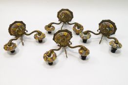 A set of four 20th century two branch wall sconces, the ceramic mounts encrusted with flowers,