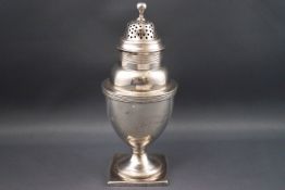 A George III silver caster, of baluster form, the pierced cover with ball knop,