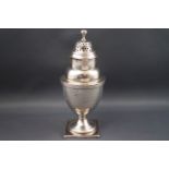 A George III silver caster, of baluster form, the pierced cover with ball knop,