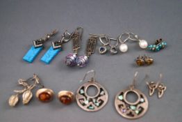 A selection of ten pairs of earrings as a mix of plain and gemset.