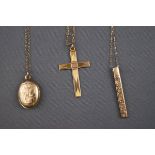 A selection of three 9ct gold pendant and chains to inclue locket, cross and ingot.