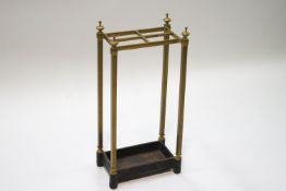 A brass stick stand with four compartments,