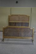 A 19th century French cane and giltwood double bed,