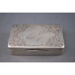 An early 20th century rectangular silver snuff box, engraved with scrolling foliage and flowers,