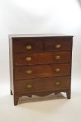A George III mahogany chest of two short over three long drawers with oval brass handles,