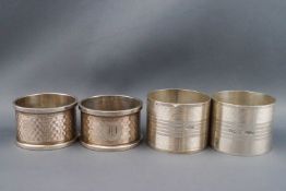 Two pairs of silver engine turned napkin rings, Birmingham 1926,