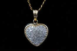 A 9ct gold and diamond heart pendant, 0.5ct I3 clarity and an 18" chain 4.