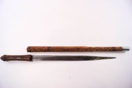 A Far Eastern dagger with leather shaft and incised diamond pattern decoration