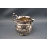 A Victorian silver milk jug with cast scroll handle,