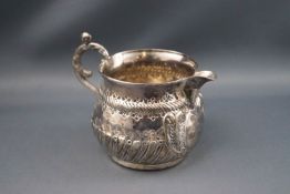 A Victorian silver milk jug with cast scroll handle,