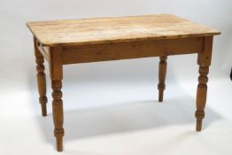 A Victorian pine kitchen table with single drawer on turned legs,