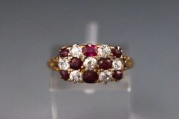 An Edwardian yellow metal dress ring set with old european cut diamonds and rubies. Stamped 18ct.