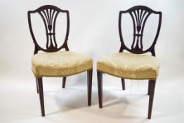 A pair of George III style shield back mahogany chairs with cream stuff over seats on cabriole legs