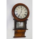 A Victorian walnut drop dial clock with eight day movement and pendulum,