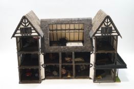 A large Tudor lodge type scratch built dolls house wtih a small amount of contents,