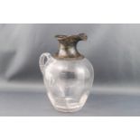 An Edwardian silver mounted clear glass ovoid decanter, the mounts with scroll pierced borders,