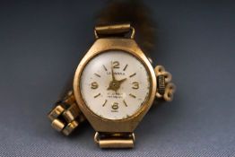A ladies wristwatch with champagne mix marking dial, signed Leonara. Manual wind 17 jewel movement.