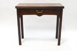 A 19th century mahogany tea table with drawer on chamfered legs and shaped apron,