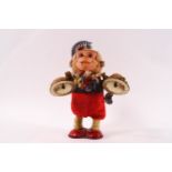 A Japanese clockwork figure of a monkey playing cymbals, 16.
