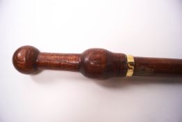 An early 20th century wooden shafted sword stick with screw top