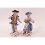 A pair of 19th century Miessen porcelain figures of a boy and girl, painted in blue and gilt,