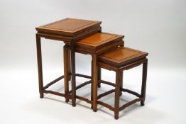A Chinese hardwood nest of three tables,