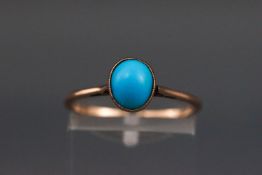 An early 20th century rose gold and turquoise single stone ring,