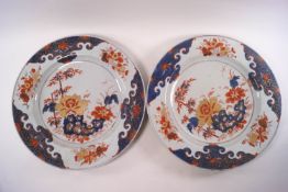 A pair of Chinese Imari circular chargers, decorated in iron red, blue and gilt with flowers,