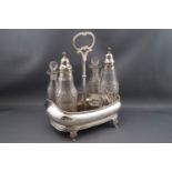 A George III silver condiment set with four cut glass bottles, two with silver pierced covers,