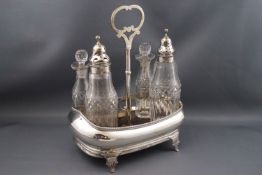 A George III silver condiment set with four cut glass bottles, two with silver pierced covers,