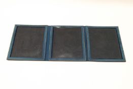A blue leather three fold photograph frame, retailed by Jarrolds Walter Jones, Sloane St, London,