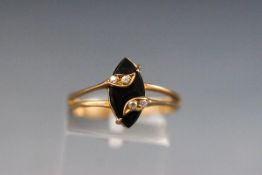 A yellow metal dress ring set with marquise onyx and four cubic zirconia.