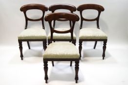 A set of four Victorian mahogany dining chairs with stuff over seats and turned legs