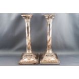 A pair of Edwardian silver plated candlesticks,