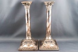 A pair of Edwardian silver plated candlesticks,