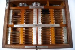 A cased set of opticians lenses by Pettie & Whitelaw within a mahogany case (not complete)
