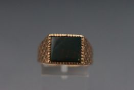 A yellow metal and bloodstone signet ring. Hallmarked 9ct gold london 1973. Size U. 7.