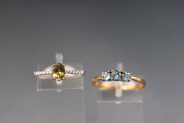 Two dress rings - a yellow metal three stone blue topaz ring, hallmarked 9ct gold, Birmingham.