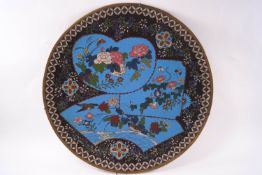 An early 20th century Japanese cloissonne plate with birds and flowers within turquoise ground