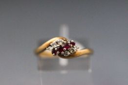 A yellow and white metal dress ring set with rubies and diamonds. hallmarked 9ct, Birmingham 1990.