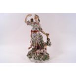 A Derby porcelain figure of Diana with a hound at her feet, holding a bow and drawing an arrow,