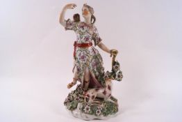A Derby porcelain figure of Diana with a hound at her feet, holding a bow and drawing an arrow,