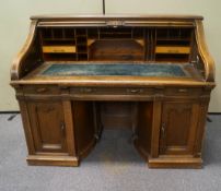 An impressive early 20th century oak roll top desk,