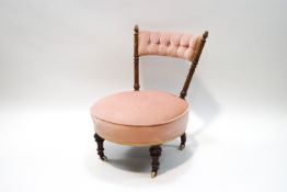 A Victorian mahogany nursing chair with carved acorn finials,