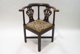 A George III style mahogany corner chair with pierced and carved side splats,