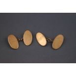 A pair of 9ct gold plain oval link cufflinks with chain fitting. Hallmarked 9ct gold, birmingham 5.