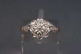 A diamond nine stone cluster ring, the eight-cut stones set in white to a yellow gold shank,