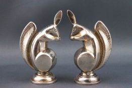 A pair of Art Deco pepper pots, in the form of squirrels, each 7cm high,