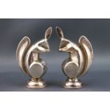 A pair of Art Deco pepper pots, in the form of squirrels, each 7cm high,