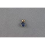 A sapphire single stone pendant, the round mixed cut bright blue stone approx .